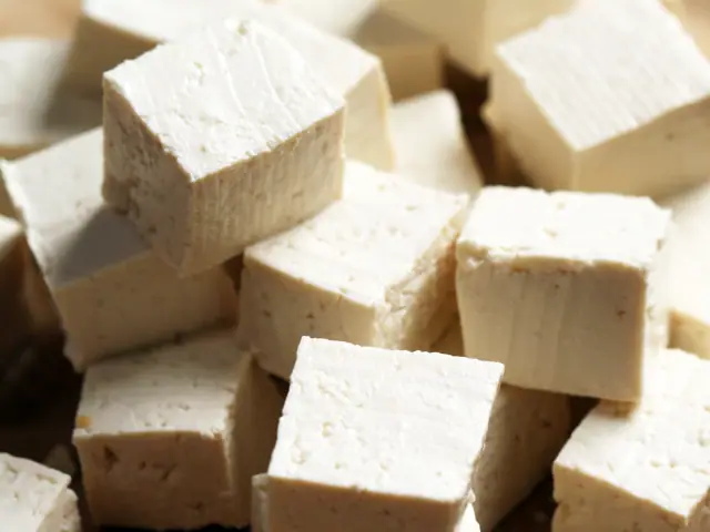 Tofu cubes on a cutting board