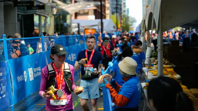 Runners receiving drinks and food at a race