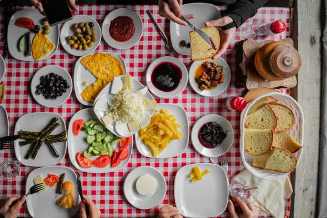 Shared Turkish breakfast on a red-checkered table