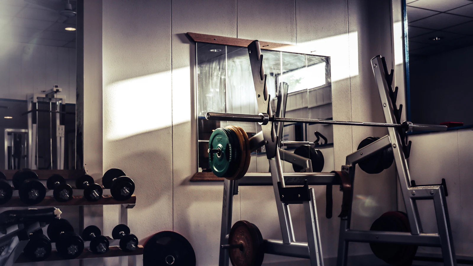 A barbell resting on a rack in a gym
