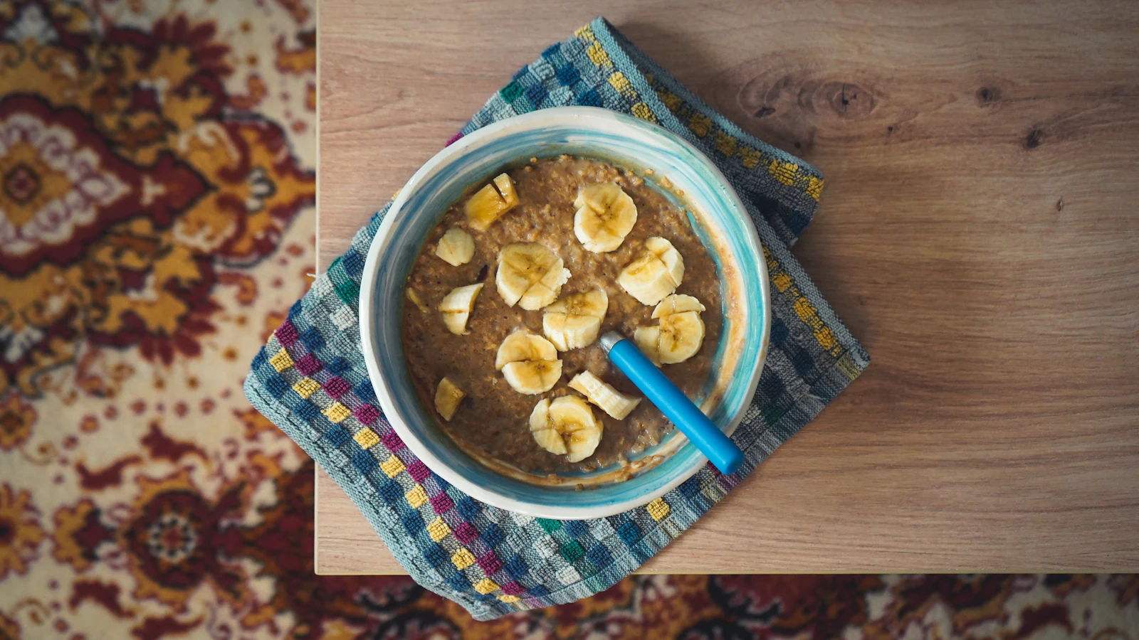 A bowl of oatmeal topped with banana slices